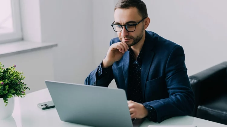 man sitting looking at a computer