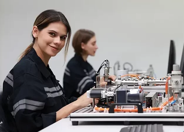 Two female mechatronic engineers with expertise in prototype automatic, learning AI automation system
